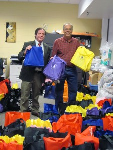 Wasilla Mayor Verne Rupright  (l) and Mat - Su Coalition on Housing and Homelessness Director Dave Rose (r) stand with bags of supplies for homeless  at Wasilla's Project Homeless Connect event on Jan. 30. Photo by Ellen Lockyer, KSKA - Anchorage.