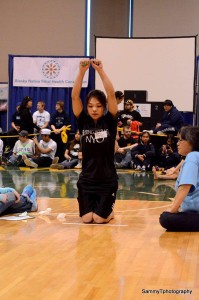 Apaay Campbell, a 16-year-old from Gambell, competes in the kneel jump at the Native Youth Olympics in Anchorage. Photo courtesy of Sammy T Photography.