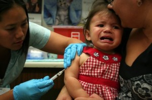 Annabelle, 1, gets an immunization for pertussis at a community health center in Richmond, California. (Photo by Anne Brice/KCAW)