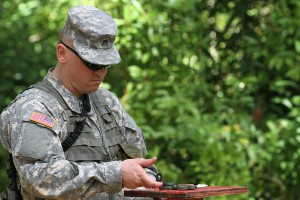 Sgt. Daniel S. Alsdorf orients himself with his compass during the land navigation course as part of the Pacific Army Reserve Best Warrior Competition, May 19. Photo by Army Staff Sgt. Joseph Vine.