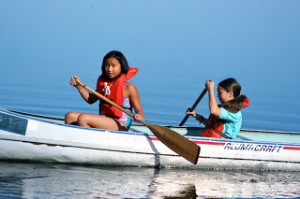 At Camp Togowoods, girls not only learn how to paddle but also how to right an overturned canoe.