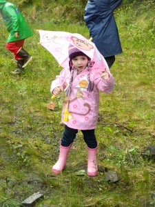 A young rainboot racer tests her pink raingear before Saturday’s race.