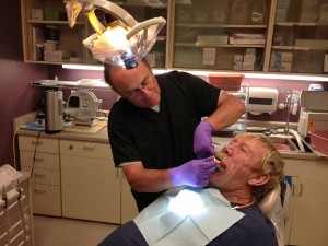 Dentist Ed Linsell takes an impression of Michael Needham’s teeth for dentures. Linsell sees about 70 patients a month. (Photo by Lisa Phu/KTOO)