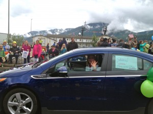 Amy Skilbred parades her electric vehicle on Fourth of July in Juneau.