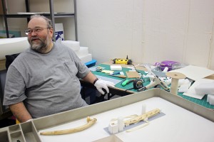 Museum professional Jon Loring takes a break from creating custom storage mounts for ivory pipes. Photo by Lisa Phu, KTOO - Juneau.