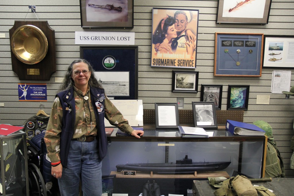 Col. Suellyn Novak poses with a model USS Grunion, a submarine lost in WWII.