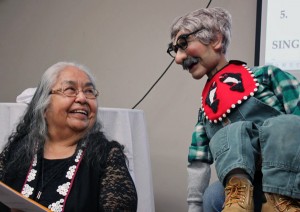 Native elder Florence Sheakley shares a warm smile with Charlie. About ventriloquism, she says, “It was awesome to see that Tlingits can do this.” Photo by Lisa Phu, KTOO - Juneau.