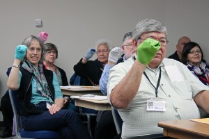 Session participants, including ANB Grand President Bill Martin and poet and translator Richard Dauenhauer, all practiced ventriloquism with sock puppets.  Photo by Lisa Phu, KTOO - Juneau.