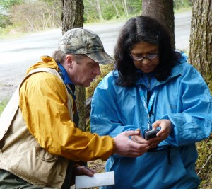 University of Alaska Southeast anthropology professor Dan Monteith goes over GPS data with Bernadine DeAsis during a dig on the UAS campus. Ed Schoenfeld CoastAlaska News