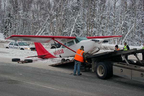 Crews load the Cessna 172 Cutlass onto a tow truck. Photo by Josh Edge, APRN - Anchorage.