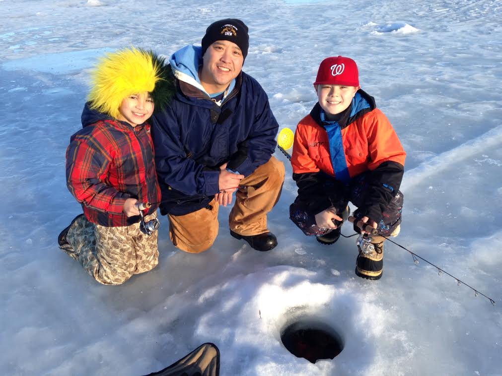Matt Sugita (center) and his sons Skyler and Teran ice fishing at Jewel Lake in Anchorage. Photo by Charles Wohlforth.