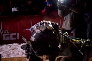 Moments after arriving at the finish line, Dallas Seavey crouches down in his sled, overcome with emotion. KNOM Photo.