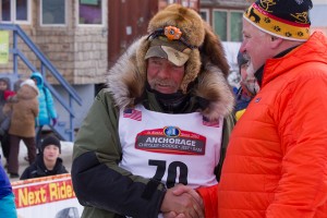 Receiving congratulations from Iditarod Trail Committee Executive Director Stan Hooley. KNOM Photo.