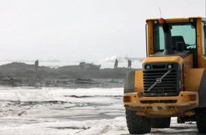 Heavy equipment at the edge of the sea ice in Nome on Monday afternoon. (KNOM photo)