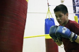 Arthur Tauilili practices punch combinations. (Photo by Josh Edge, APRN - Anchorage)