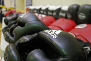 Rows of headgear and gloves are set out prior to practice. (Photo by Josh Edge, APRN - Anchorage)