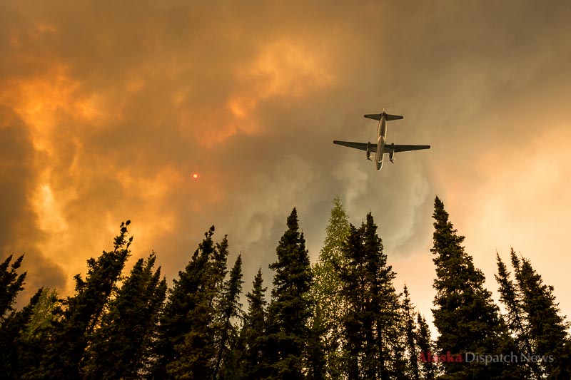 An airplane prepares to drop retardant on a fire burning on the edge of Browns Lake in the Funny River neighborhood of Soldotna on Saturday afternoon, May 24, 2014. The Funny River fire burned over 100,000 acres on Alaska's Kenai Peninsula.