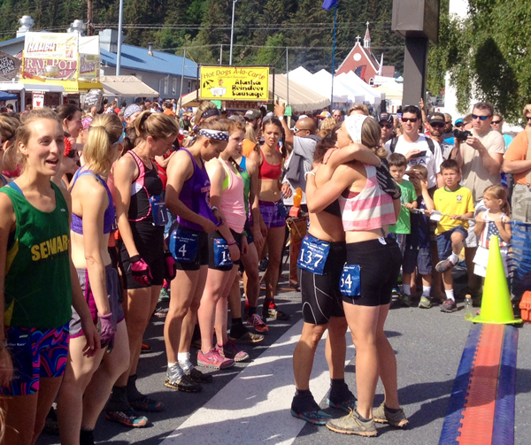 Holly Brooks hugs fellow competitor Charlotte Edmondson before race. (Photo by Alexandra Guitierrez, APRN - Seward)