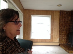 Jill Reese talks about the project inside one of the homes slated for removal. Hillman/KSKA