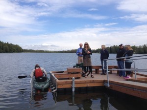 Project proponents speak as Ira Edwards tests out the new accessible dock on Jewel Lake.