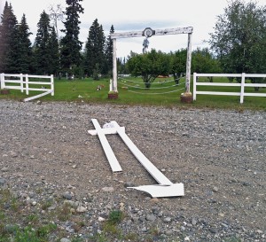 A chunk of broken fencing lies on the ground where the vandals apparently exited the cemetery. (Photo by Tim Ellis, KUAC - Fairbanks)