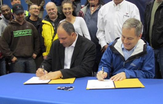 Adam Beck and Gov. Sean Parnell sign the contact for Vigor Alaska to build two new state ferries.