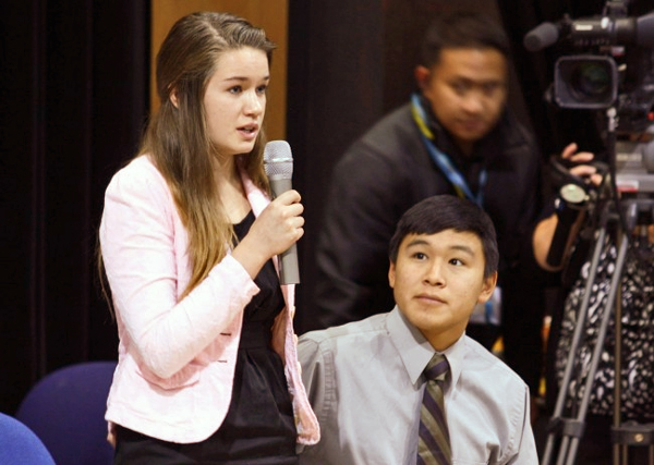 Nelson Kanuk, seated, and Katherine Dolma, standing, were two of the six young plaintiffs who sued the State of Alaska, demanding it take action on climate change. The pair are pictured here in Barrow, following a Supreme Court LIVE hearing at Barrow High School.  (Photo by Jeff Seifert/ KBRW)