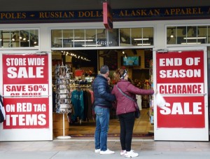 Tourists consider checking out a sale on South Franklin Street, Juneau’s gift-shop row, on one of the last days of 2014′s tourism season. (Photo by Ed Schoenfeld/CoastAlaska News)