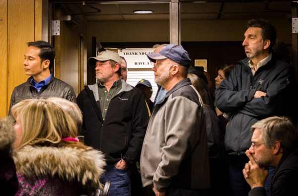 Business owners, nonprofit workers, and residents (including Rep. Neal Foster, left) made for a full house in Nome City Council chambers Monday as the council debated contentious tax issues. (Photo: Matthew F. Smith, KNOM)