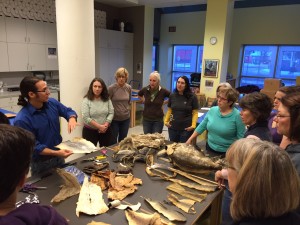 Joel Isaak shows off different fish skin leather examples during a workshop at the Anchorage Museum. Hillman/KSKA