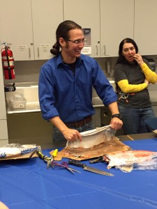 Joel Isaak demonstrates skinning fish and cleaning the skin at a workshop at the Anchorage Museum. Hillman/KSKA