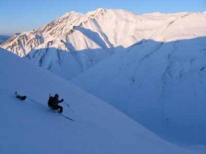 Happy memory: Michael Hopper slices through powder on a telemark turn down a slope in the Eastern Alaska Range near Black Rapids with his canine companion Rowdy back in 2010. (Credit Mike Hopper)