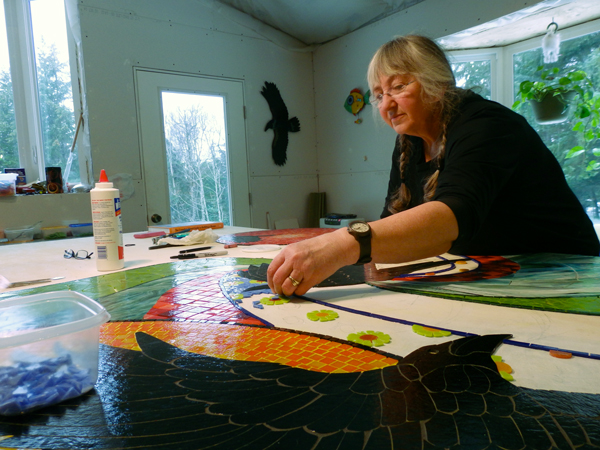 Sharon Svenson works on the “Taking Flight” mosaic.