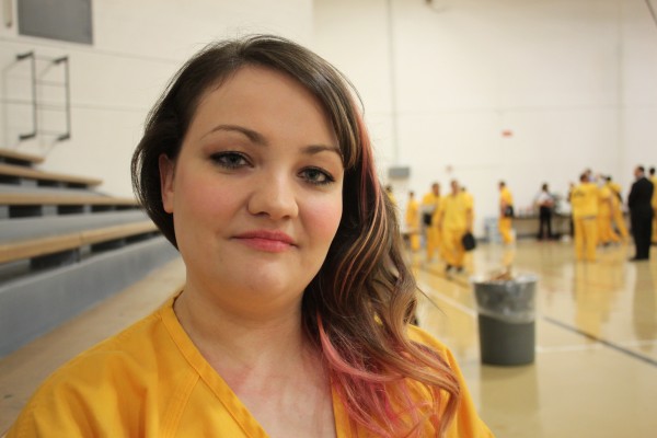 Catherine Fredrick at a prison event in the Lemon Creek Correctional Center gymnasium. Fredrick lives in the tent. (Photo by Lisa Phu/KTOO)