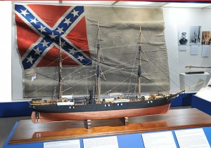 Model of Shenandoah, in front of her Confederate flag, the last lowered in surrender.