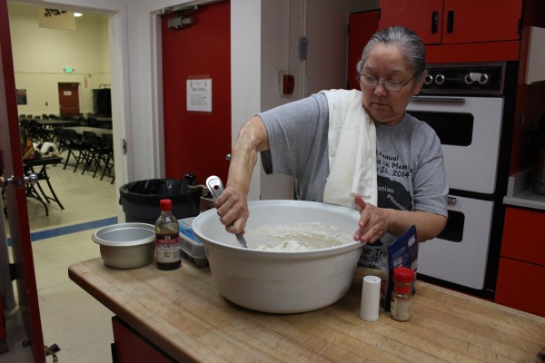 Siouxbee Lindoff mixes the kulich dough by hand (Photo by Elizabeth Jenkins/KTOO)