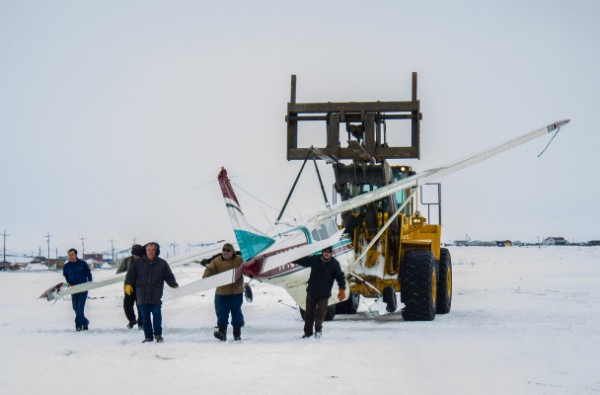 A team of responders transporting the damaged Cessna 185 after it landed at Nome’s City Field on Thursday afternoon. (Photo: Francesca Fenzi)