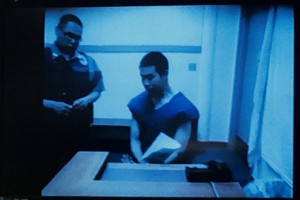 A guard appeared with 24-year-old Justine Paul by video from the Yukon Kuskokwim Correctional Center for arraignment on First Degree Murder charges. – Photo by Daysha Eaton/KYUK