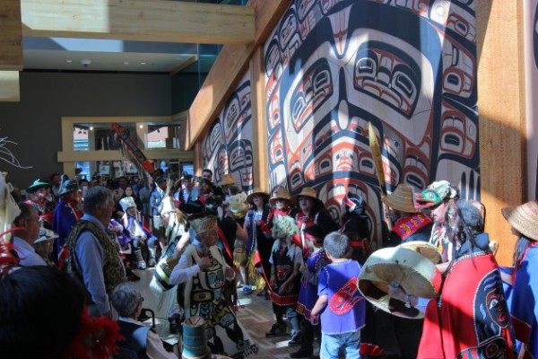 Singers in front of the newly unveiled artwork on the clan house (Photo by David Purdy/KTOO)