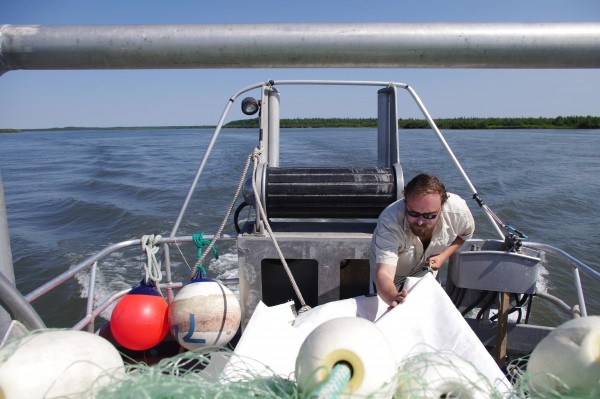 Jonathan Flora makes a hammock from net bags onboard the F/V Eagle Claw June 17, 2015.