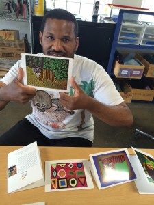 Andre Hogg shows off note cards with his  paintings. Photo courtesy of Sparc!
