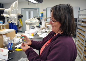 Anne Jensen examines artifacts in her lab. (CREDIT ANNE JENSEN)