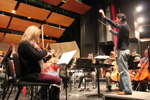 Conductor Troy Quinn leads the Juneau Symphony during rehearsal at the Juneau-Douglas High School auditorium. (Photo by Lisa Phu/KTOO)