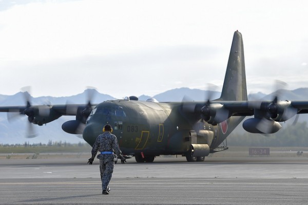 A Japanese Air Self-Defense Force airman directs a taxiing C-130H Hercules on Joint Base Elmendorf-Richardson, Alaska, Aug. 11, 2015. The JASDF contingent is on JBER to participate in Red Flag 15-3, a series of Pacific Air Forces commander-directed training exercises for U.S. and international forces to provide joint offensive, counter-air, interdiction, close air support, and large force employment in a simulated combat environment. (U.S. Air Force photo/Alejandro Pena)