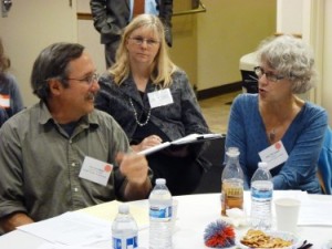 Guy Archibald of the Southeast Alaska Conservation Council, left, discusses issues with Sitka Mayor Mim McConnell, right, during Thursday’s transboundary mine meeting in Juneau. (Photo by Ed Schoenfeld/CoastAlaska News)