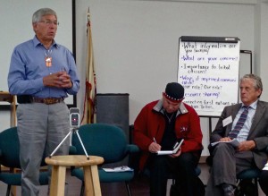 Lt. Gov. Byron Mallott speaks at a Wednesday tribal meeting in Juneau on transboundary mines. United Tribal Transboundary Mining Work Group Co-Chair Rob Sanderson Jr., center, and Fish and Game Commissioner Sam Cotten, right,  listen. (Photo by Ed Schoenfeld/CoastAlaska News)