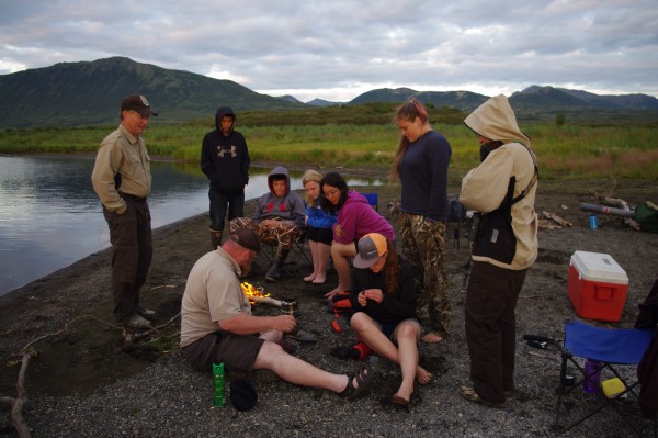 Togiak National Wildlife Refuge Education Specialist Terry Fuller shows students, and adult chaperones, fire-starting skills at Pungokepuk Lake on August 5, 2015.