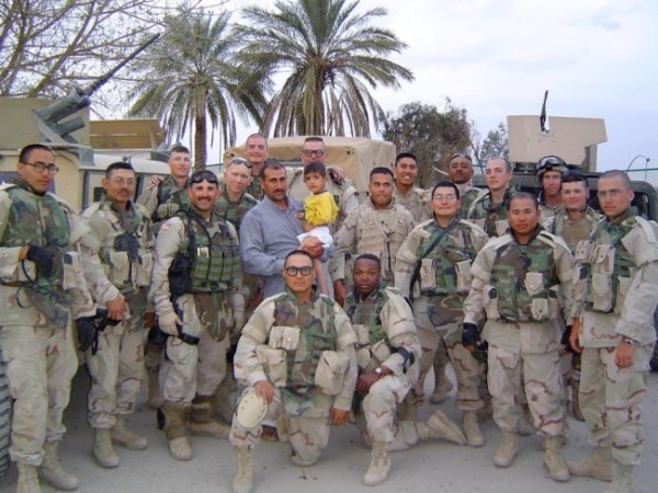 Joseph Murphy (from left, first man kneeling) served in the Iraq War. The squad was led by Ed Irizarry (standing to the left above Murphy). Mike Mercer (far right) was a gunner with Murphy. (Photo courtesy Ed Irizarry)