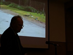 Jay Smith stands before a photo of Jeff Dusenbury's bike as it lay where he was hit and killed. Hillman/KSKA