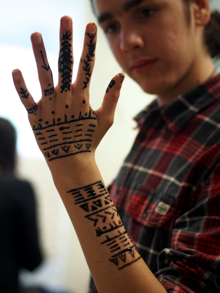 Jacobsen's son Benjamin came with her from Greenland, and shows off self-administered henna designs made of different traditional patterns, but reconfigured. (Photo: Zachariah Hughes, KSKA).